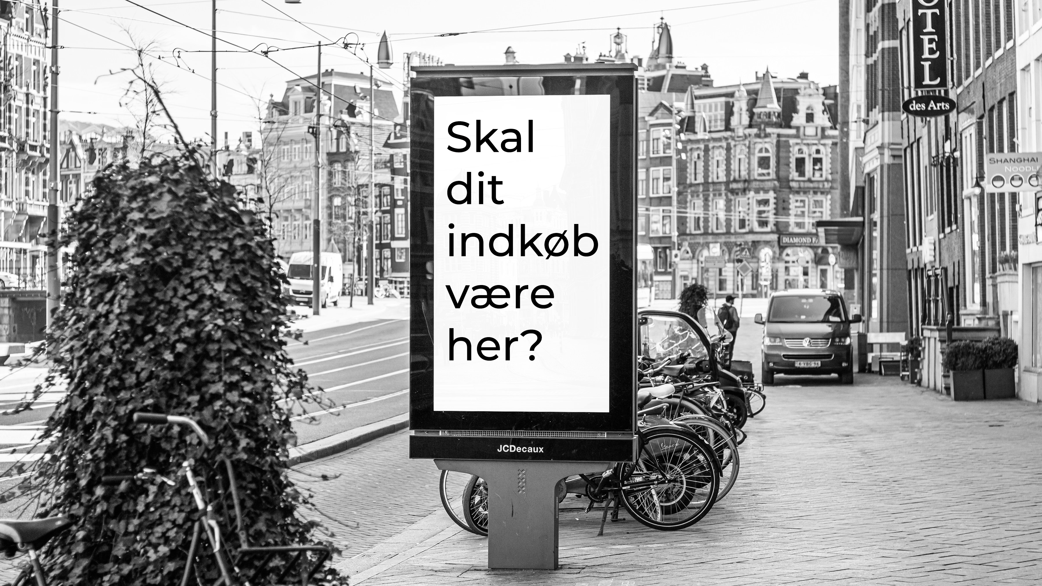 Foto af skilt med teksten &quot;Skal dit indkøb være her?&quot;